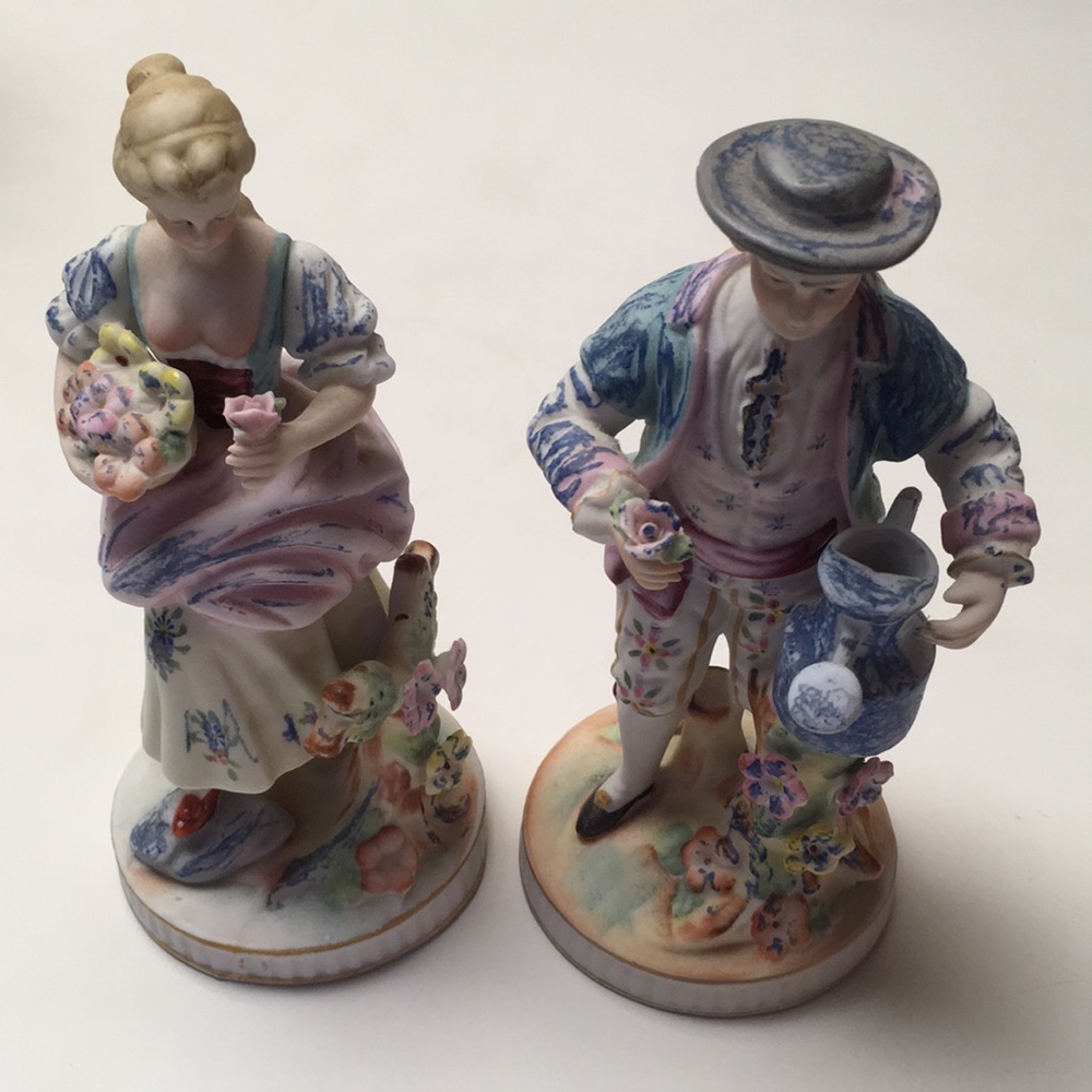 Two vintage hand-painted porcelain figurines.